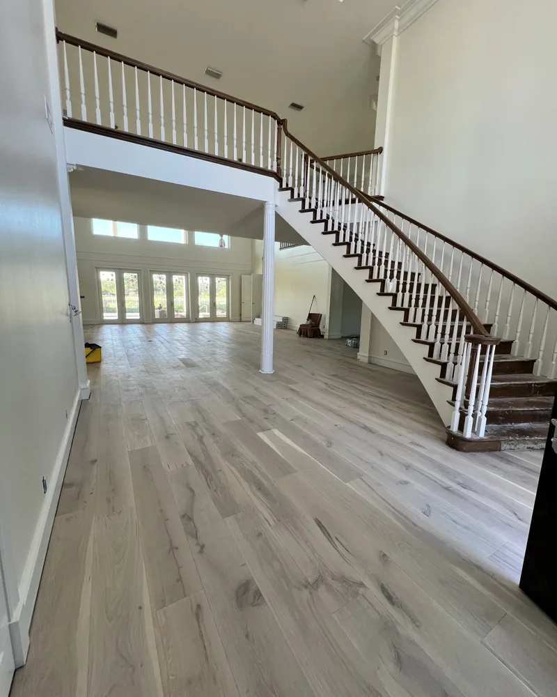 Process: new wide-plank white-oak style wood floors installed through the foyer and great room, walls and ceilings freshly painted