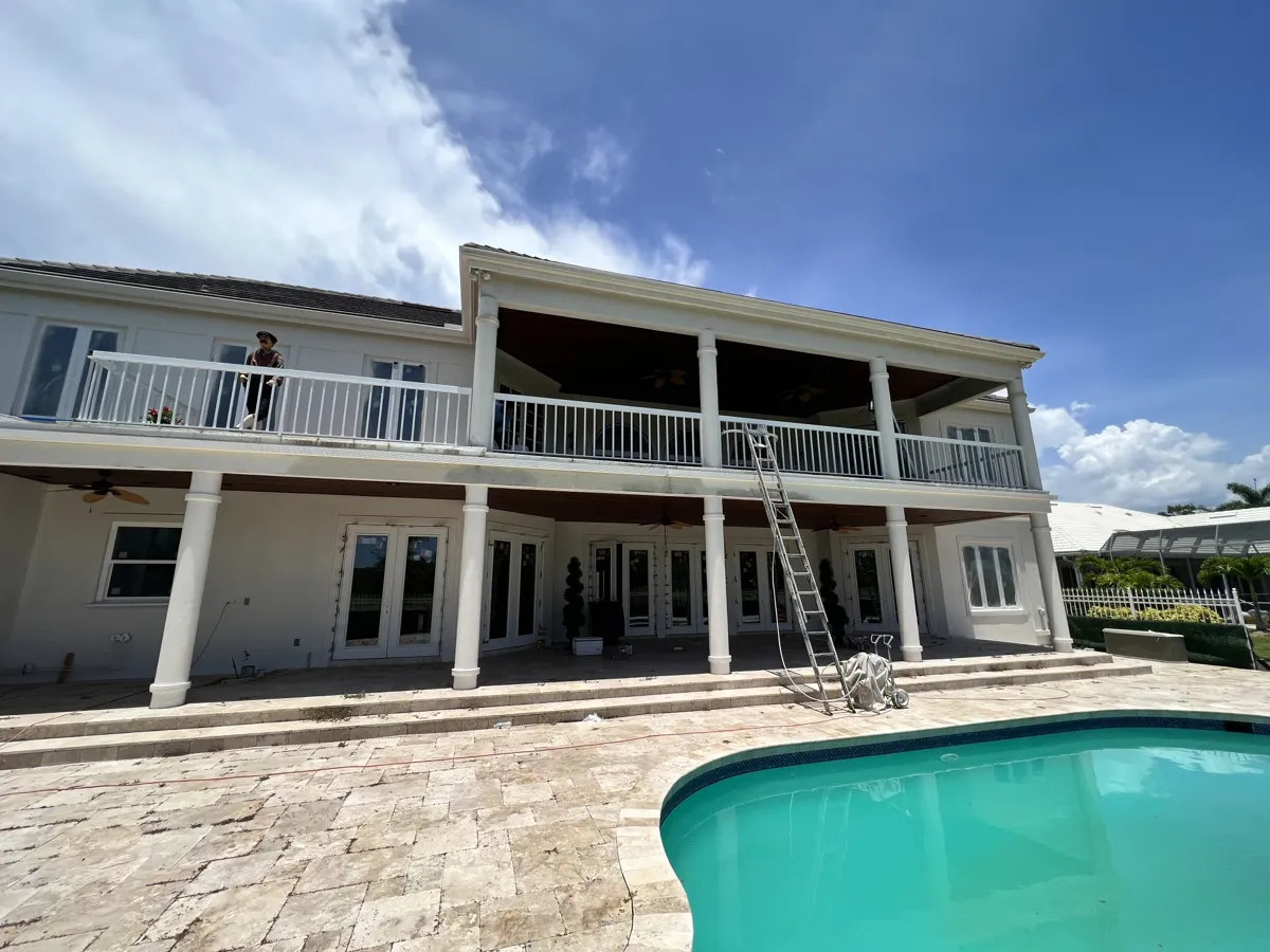 Rear of a two-story stucco home in Prestancia, Sarasota, with double balconies and pool during exterior prep
