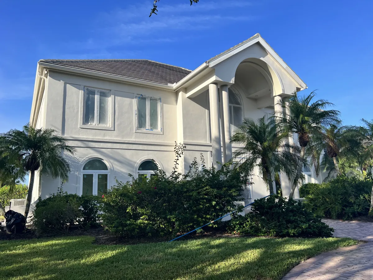 Side elevation with windows masked and fresh light stucco paint