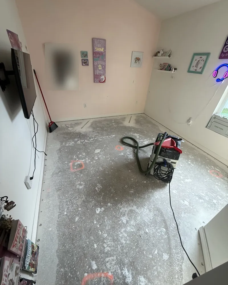 Before: bedroom slab after the old flooring was removed, scraped and prepped with a dust extractor