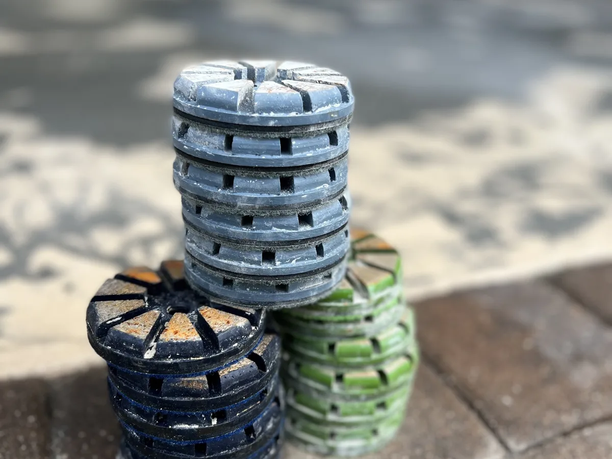 Worn diamond grinding pads stacked after removing the old floor coating