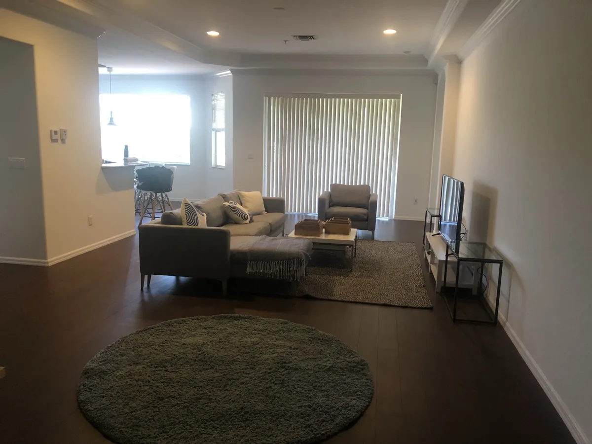 After: bright living room with fresh white walls, ceiling and crown molding
