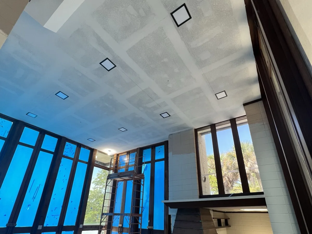 After: new drywall ceiling hung, taped and finished with square recessed light openings, ready for paint