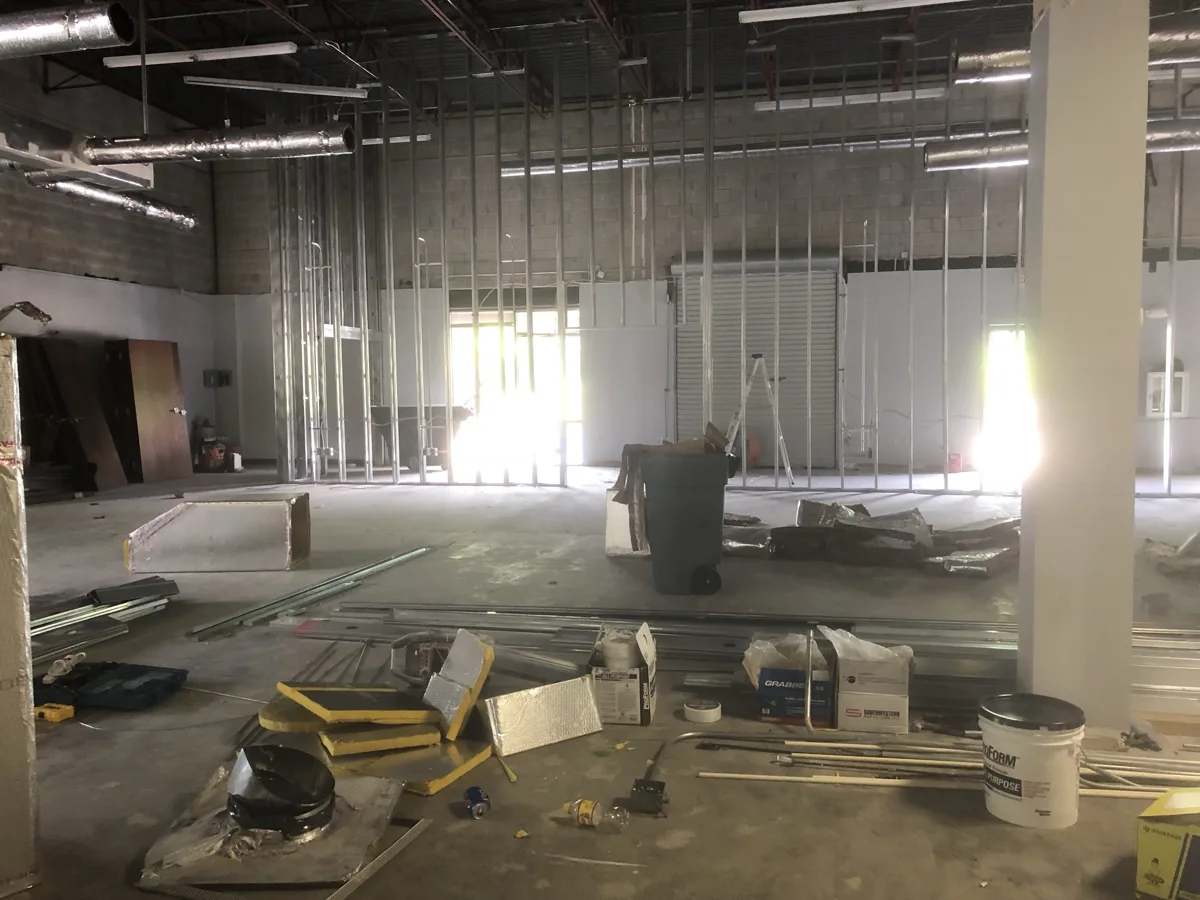 Framing: metal stud walls going up inside an open commercial shell