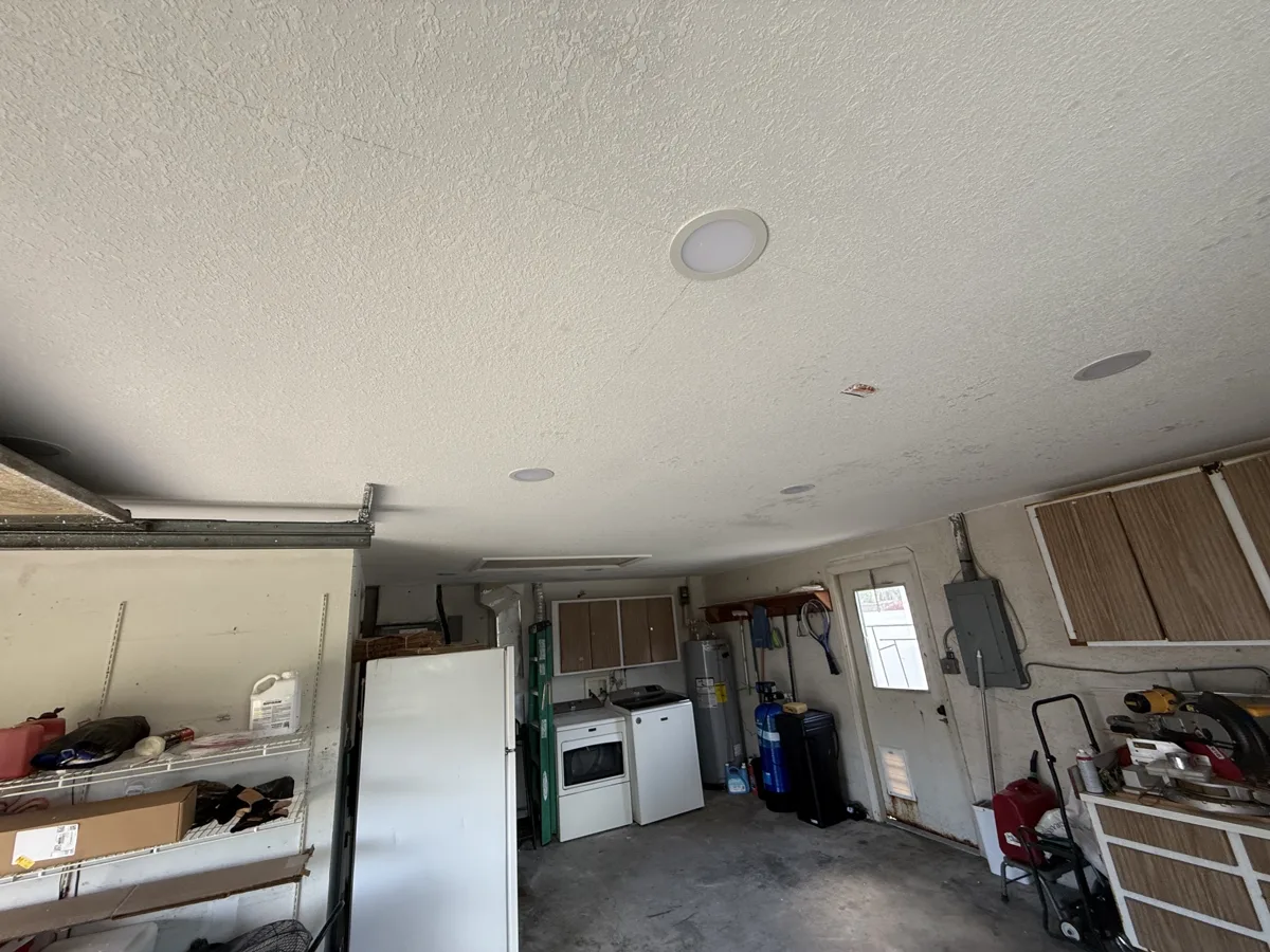 After: garage ceiling with sprayed texture and primer, recessed lights installed