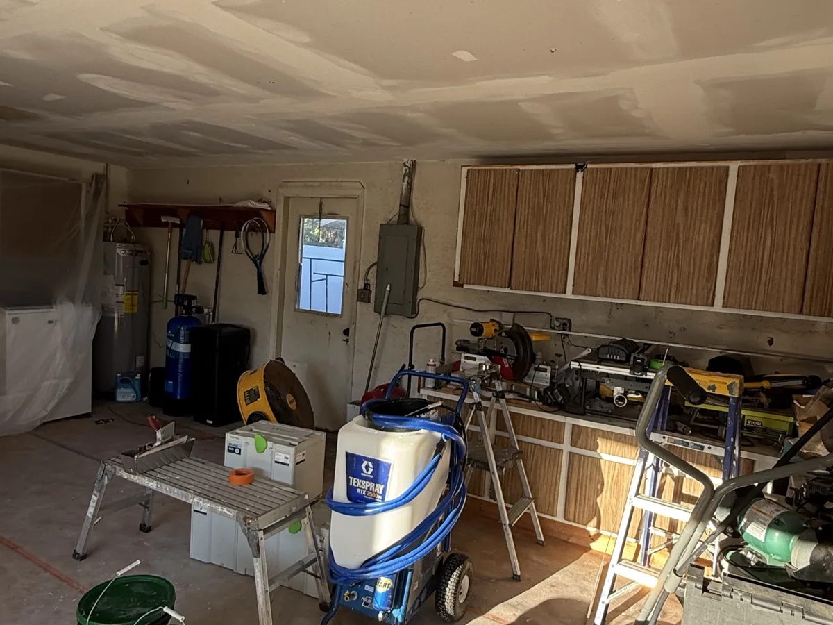 During: new garage ceiling drywall hung, taped and mudded, Graco TexSpray and Festool HEPA extractor on site