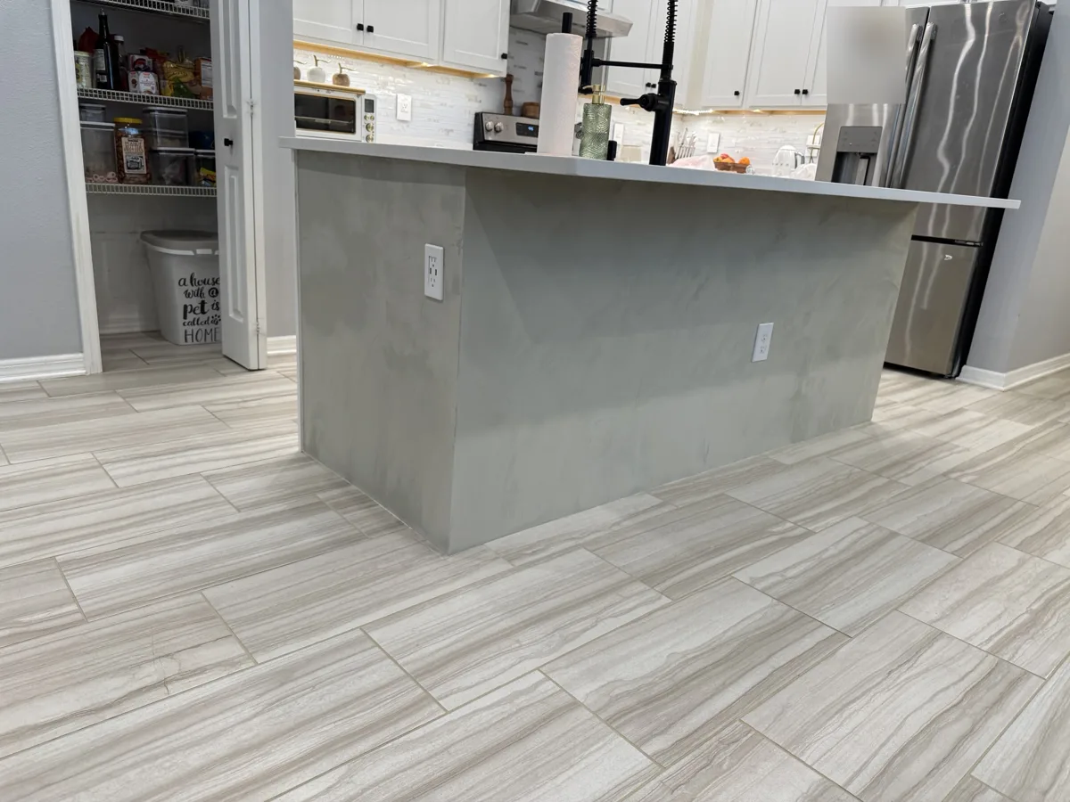 After: the full island in gray Venetian plaster under the white quartz countertop