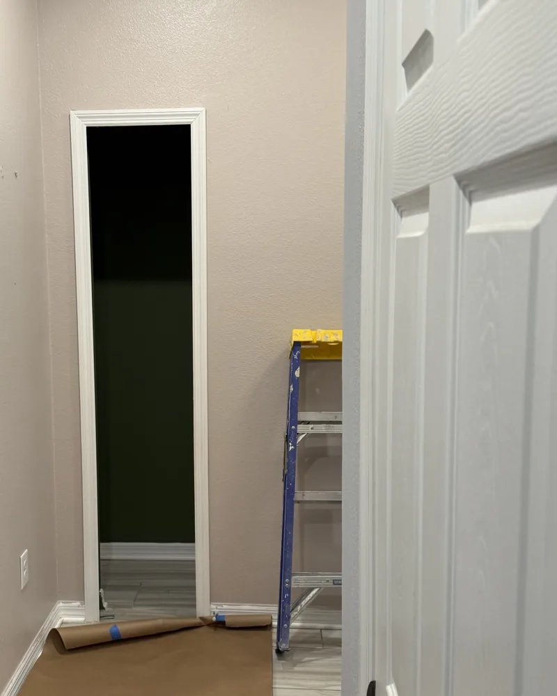 Before: narrow rectangular cased opening at the end of a hallway